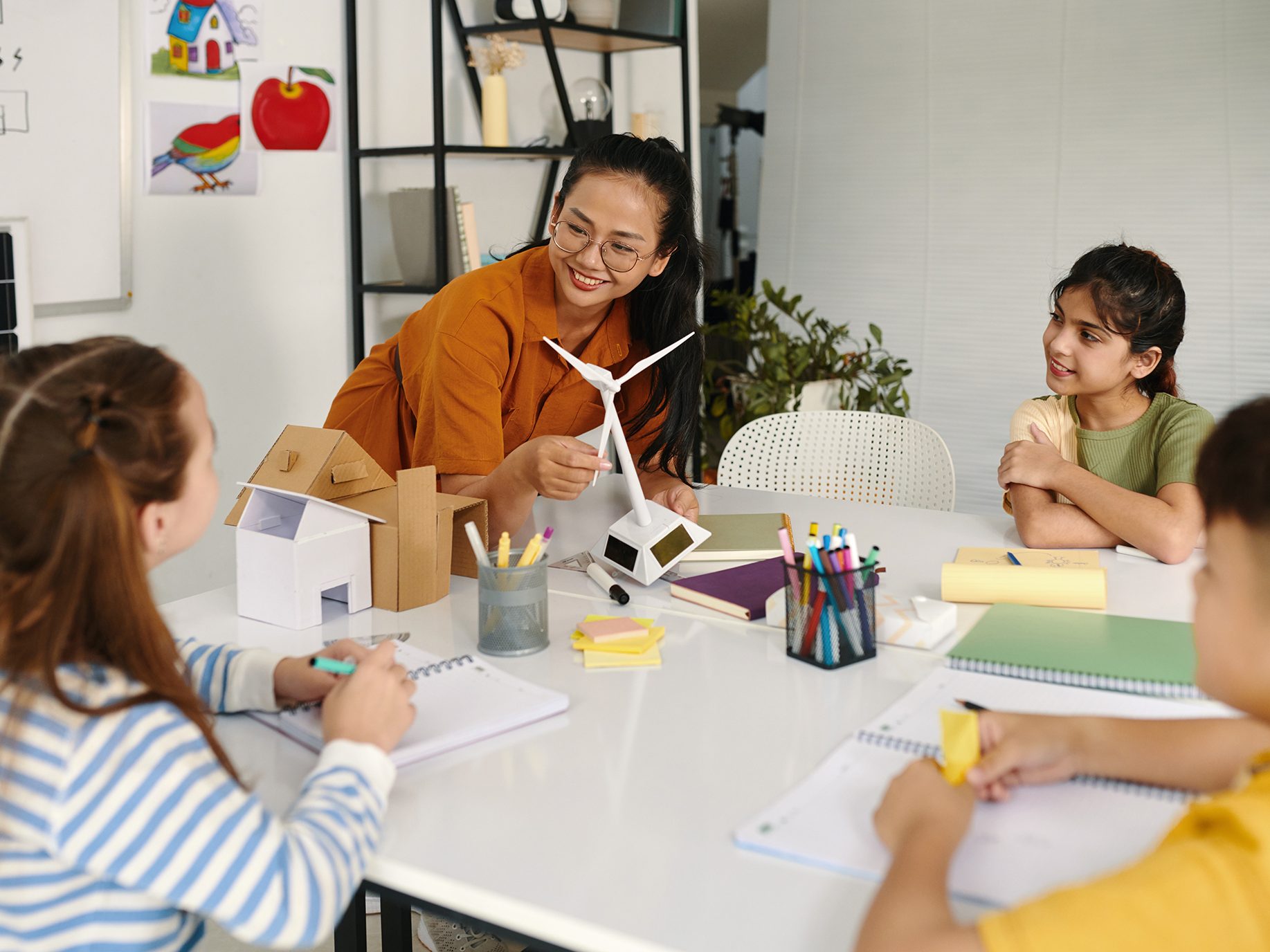 Image of a teacher showing how wind energy works to students.