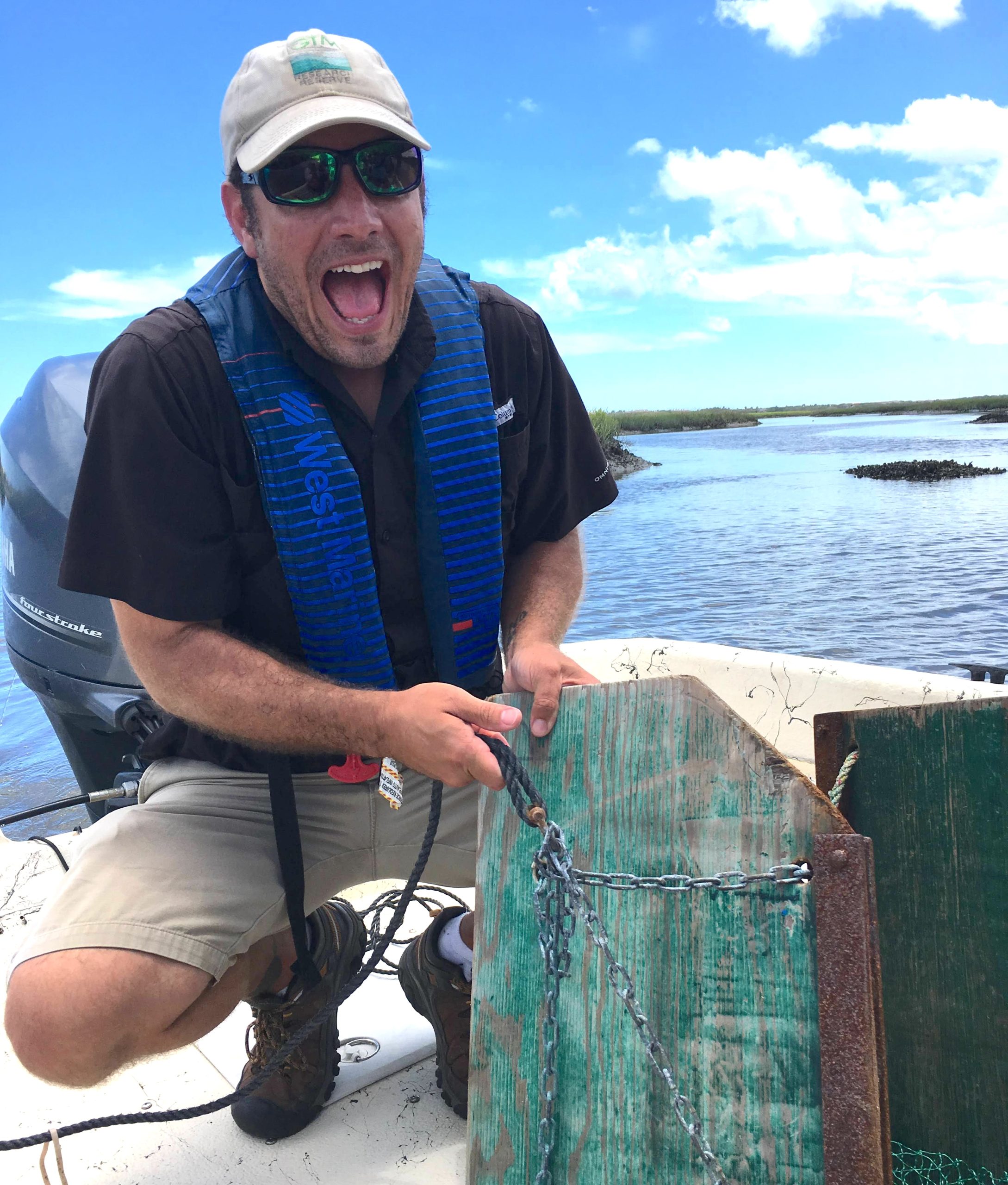 Image of Kenneth Rainer on a boat with an otter trawl. This image is for the contact page.